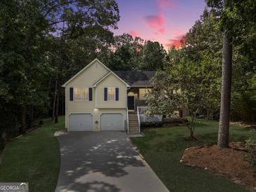 Charming split-level home with a two-car garage and lush landscaping, perfect for families seeking comfort at 169 Knights Ct, Dallas, GA 30157