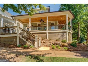 Inviting front porch with wood ceiling, fan, railing, and stairs at 5106 N Pratt St, Covington, GA 30014