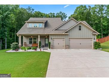 Charming home with a two-car garage, manicured lawn, and inviting front porch at 132 Whitworth Dr # 15, Locust Grove, GA 30248