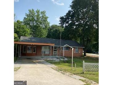 Charming single-story home with a covered parking area and front yard at 213 Whipporwill Way, Riverdale, GA 30274