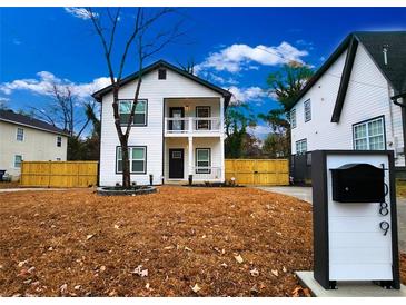 Charming two-story home with a welcoming front porch and manicured lawn, perfect for curb appeal at 1089 White Oak Sw Ave, Atlanta, GA 30310