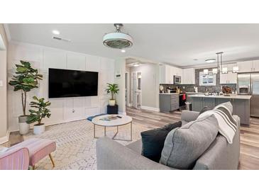 Cozy living room featuring stylish furniture, modern decor, and an open floor plan to the kitchen at 3182 Lake Ave, Atlanta, GA 30354