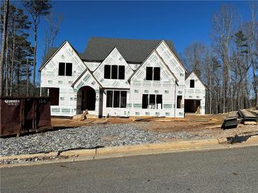 Two-story home under construction, showcasing a charming facade and architectural details at 871 Woodvale Pt, Suwanee, GA 30024