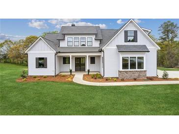 Beautiful two-story home with covered entrance and manicured lawn at 170 Ewing Way, Dacula, GA 30019