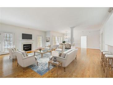 Bright living room with hardwood floors, fireplace, and ample seating at 211 Colonial Homes Nw Dr # 1303, Atlanta, GA 30309