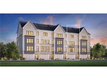 Three-story townhouses with modern design, two-car garages, and landscaped lawn at 2714 Thornwilde Se Ln, Vinings, GA 30339