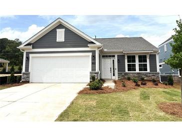 Charming single-story home with gray siding, white trim, stone accents, and a well-maintained front yard at 128 Laurel Farms Ln, Dallas, GA 30157