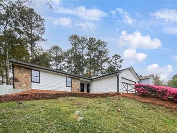 Charming single-story home with stone accents and a lush green lawn, perfect for suburban living at 2713 Laurel View Dr, Snellville, GA 30039