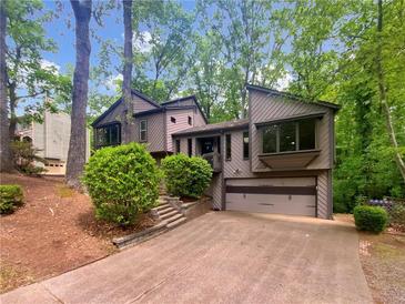 Charming two-story home with mature trees, and a two-car garage in a wooded area at 2864 Sudbury Ct, Marietta, GA 30062