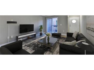 Spacious living room with modern furniture and access to a private balcony at 385 Ralph Mcgill Ne Blvd # Q, Atlanta, GA 30312