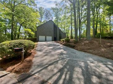 Charming two-story home with a two-car garage nestled among mature trees, offering a serene setting at 3213 Cedar Bluff Ne Dr, Marietta, GA 30062
