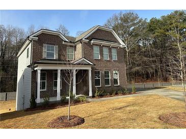 Brick two-story house with front yard and driveway at 565 Abbott Se Ct, Atlanta, GA 30354