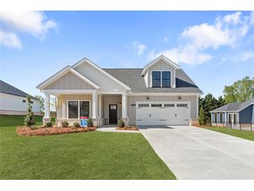 Charming single-Gathering home with a well-manicured lawn and an attached two-car garage at 5235 Maggie Mae Ln, Cumming, GA 30028