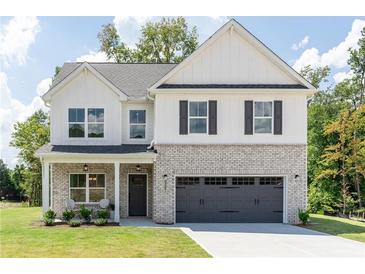 Charming two-story home with gray brick accents and a covered front porch at 3378 Pepperpike Ct, Loganville, GA 30052