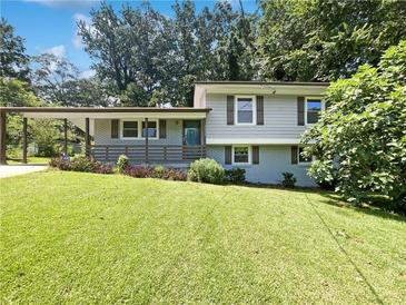 Charming split-level home with covered carport, fresh lawn and mature trees in a quiet neighborhood at 2492 Brentwood Ct, Decatur, GA 30032
