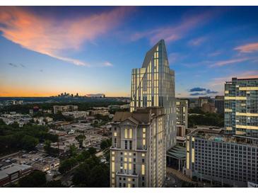 Stunning aerial view of a modern building against a colorful sunset sky at 3324 Peachtree Ne Rd # 2718, Atlanta, GA 30326