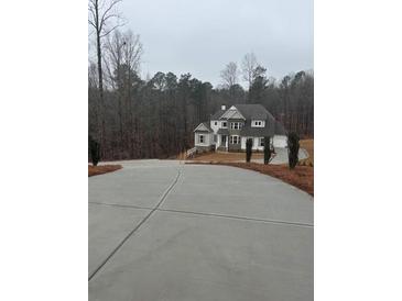 Two story house with stone accents and a large driveway at 3730 Reserve Overlook (Lot 8) Way, Cumming, GA 30041