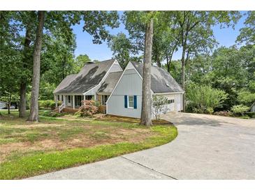 Ranch home with attached garage, situated on a landscaped lot with mature trees at 5622 Williamsburg Dr, Norcross, GA 30093