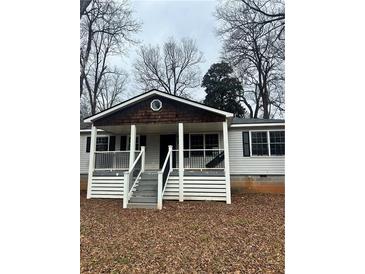 Charming single-story home featuring a quaint front porch with classic architectural details at 115 Montgomery St, Atlanta, GA 30317