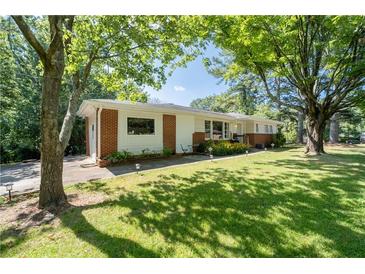 Charming home featuring a well-manicured lawn and beautiful mature trees offering plenty of shade and curb appeal at 2785 Toney Dr, Decatur, GA 30032