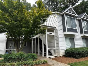 Inviting condo building with landscaping and well-maintained grounds at 17 Fair Haven Se Way, Smyrna, GA 30080