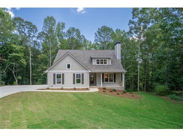 Craftsman style home with gray siding, landscaping, and driveway at 939 Jean Ct, Covington, GA 30014