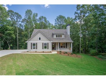 Charming one-story house with gray siding, a large yard, and a tree-lined backdrop at 939 Jean Ct, Covington, GA 30014