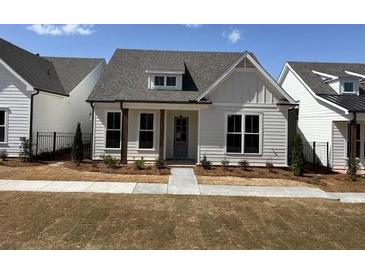 Charming single-story home featuring white siding, a gray roof, and a well-manicured lawn at 503 Godfrey Dr, Cumming, GA 30040