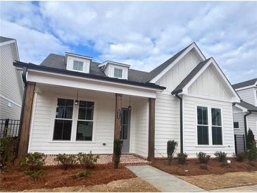 White farmhouse exterior with a front porch and landscaping at 505 Godfrey Dr, Cumming, GA 30040