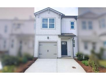 Charming two-story home with shaker siding, concrete driveway, and attached single car garage at 5895 Mattan Trl # 68, Lithonia, GA 30058