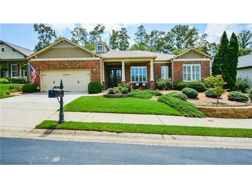 Charming brick home featuring a well-manicured lawn and an inviting covered entryway at 705 Springer Mountain Dr, Canton, GA 30114