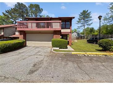 Inviting two-story home with a balcony, garage, and well-maintained landscaping at 1084 Village Main St, Stone Mountain, GA 30088