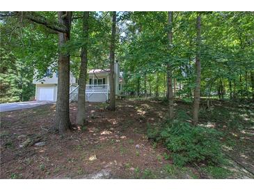 Charming ranch home nestled in a wooded lot with a spacious driveway at 204 Wesley Mill Ln, Villa Rica, GA 30180