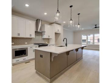 Modern kitchen with stainless steel appliances and island at 1980 Deco Dr, Kennesaw, GA 30144