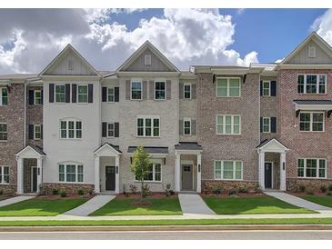 Charming townhome exteriors with brick and siding, complemented by well-maintained landscaping and inviting entryways at 1988 Deco Dr, Kennesaw, GA 30144