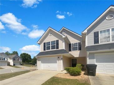 Inviting two-story home featuring a one-car garage and manicured landscaping at 201 Gallant Se Ln # 25, Mableton, GA 30126