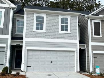 Charming two-story home with a gray exterior, garage, and well-maintained landscaping at 5142 Longview Run, Decatur, GA 30035