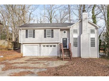 Two-story house with attached two-car garage and wooden stairs leading to the front entrance at 2920 Cushing Ct, Jonesboro, GA 30236