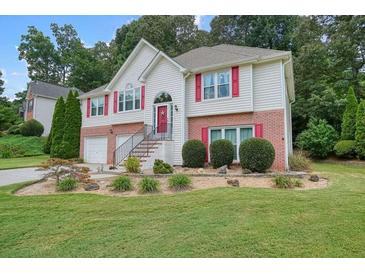 Charming two-story home with brick accents, well-manicured landscaping, and inviting curb appeal at 1215 Wandering Vine Ct, Mableton, GA 30126