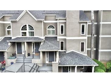 Charming townhome with a modern gray exterior, inviting entrance, and well-maintained landscaping at 14 Saint Claire Ne Ln, Atlanta, GA 30324