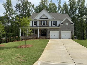 Beautiful two-story home with brick and siding, complemented by a well-manicured lawn and a two-car garage at 1065 Low Water Nw Xing, Acworth, GA 30101