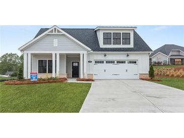 Charming single-Gathering home featuring a welcoming front porch and a two-car garage at 5365 Maggie Mae Ln, Cumming, GA 30028
