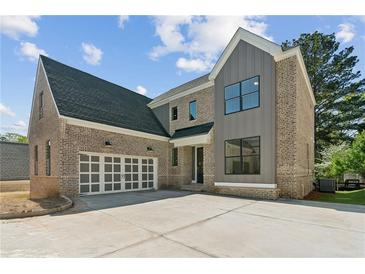 Beautiful brick home with a two-car garage and modern gray accents at 104 Cottage Gate Ln, Roswell, GA 30076