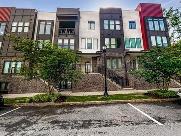 Modern townhome exterior with brick accents, multiple stories, and a well-maintained lawn at 371 Pratt Se Dr # 203, Atlanta, GA 30315
