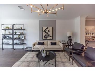 Bright living room with modern furnishings, stylish decor, and a unique chandelier at 626 Skytop Dr # 159, Cumming, GA 30040