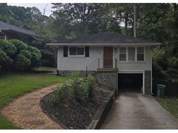 Charming single-story home with a stone accent wall and driveway parking at 2121 Arlington Ne Ave, Atlanta, GA 30324