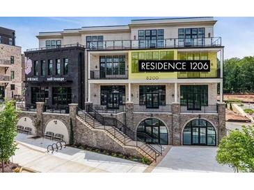 Modern condo building with brick facade and many windows, conveniently located near shops and restaurants at 8200 Main St # 1206, Woodstock, GA 30188