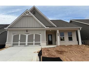 Charming single-story home with a two-car garage and a beautifully designed front entrance at 625 Moorhen Way, Loganville, GA 30052