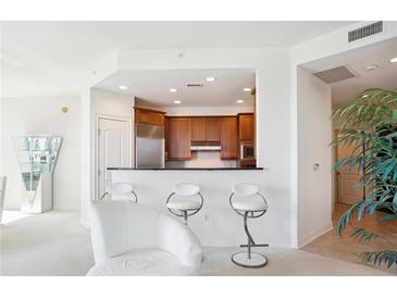 Bright open kitchen with stainless steel appliances and sleek bar seating at 2828 Peachtree Nw Rd # 2002, Atlanta, GA 30305