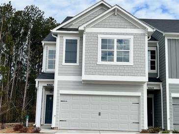 Charming two-story home with a gray facade, a two-car garage, and a well-maintained lawn at 5174 Longview Run, Decatur, GA 30035